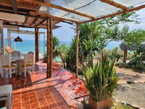 a patio with a table and a view of the ocean at Casa Las Mantas Santa Marianita in Santa Marianita