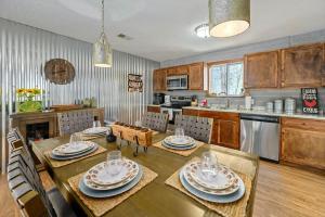 a kitchen with a wooden table and a dining room at Happy Trails Stunning Smoky Mtn Views Hot Tub Game Room Resort Pools in Gatlinburg +45 photos