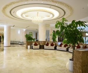 a lobby with couches and a chandelier at Anbar International Hotel in Kumaysh +45 photos