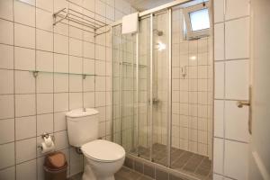 a bathroom with a toilet and a glass shower at Hotel Angel Beach - Kızkalesi Mersin in Erdemli
