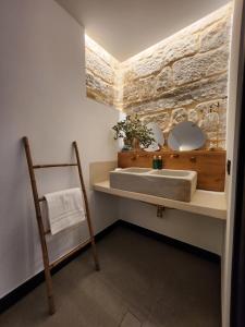a bathroom with a sink and a mirror at La Kasilla in Baeza