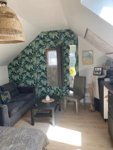 a living room with a couch and a chair at chambre spacieuse indépendante PDJ inclus in Plougastel-Daoulas