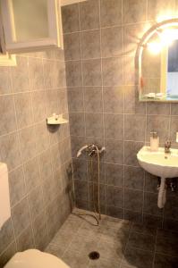 a bathroom with a shower and a toilet and a sink at Litsas Studios Kythnos in Kithnos +51 photos