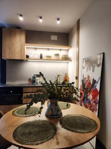 a dining room table with a vase with plants on it at La Kasilla in Baeza +14 photos