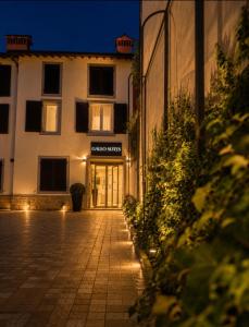 a building with a sign that reads hotel sigma strings at Galeo Suites in Florence