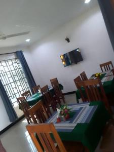 a dining room with a green table and chairs at Katavi Empire Hotel in Mpanda