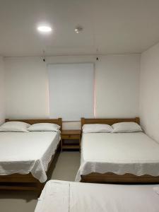 a room with two beds and a window at yasa by SEA CRAB in San Andrés