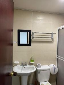 a bathroom with a sink and a toilet and a mirror at yasa by SEA CRAB in San Andrés