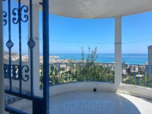 a balcony with a view of the ocean at Villa rafraf al hmeri in Rafrāf