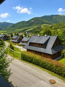 a house with a gray roof on a mountain at Drevenica Podkovička - Terchová in Terchová