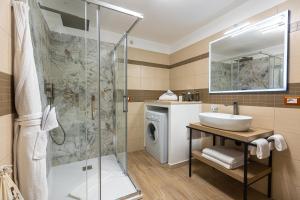 a bathroom with a sink and a shower at Marta Lake Albergo Diffuso & Spa in Marta +70 photos