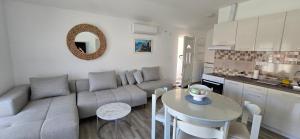 a living room with a couch and a table at Apartmani Furesti 2 in Donji Stoliv