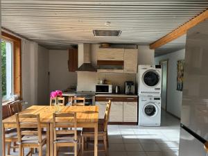 a kitchen with a wooden table and a dining room at Puuna Öömaja B&B in Vihterpalu