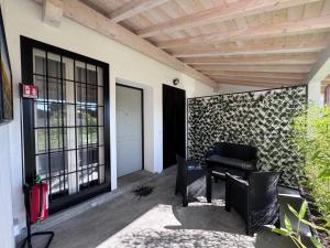 a patio with a table and chairs next to a door at The Terry Inn in Frascati
