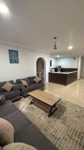 a living room with a couch and a table at Al-Dana 6 in Al Wajh +7 photos
