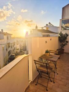 a table and chairs on the balcony of a building at Charming Lagos Stay - Walk to Beach & Historic Centre in Lagos +24 photos
