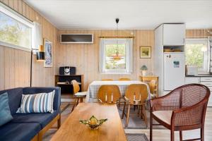 a living room with a couch and a table at FY140-Middelfart-Regulusvej-32 in Middelfart