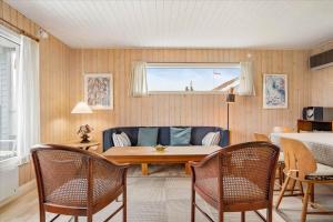 a living room with a couch and a table and chairs at FY140-Middelfart-Regulusvej-32 in Middelfart +14 photos