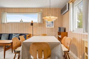 a dining room with a table and chairs at FY140-Middelfart-Regulusvej-32 in Middelfart