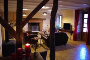 a living room with couches and a fireplace at la prade basse in Saint-Antonin