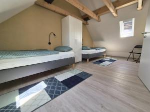 a room with two beds and two rugs at Boendgen's Ferienhaus mit Moselblick in Zell an der Mosel