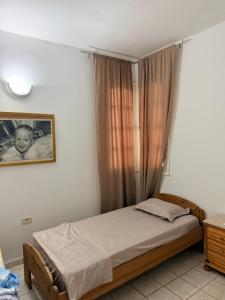 a bedroom with a bed and a picture of a baby at Villa rafraf al hmeri in Rafrāf