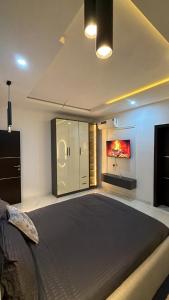 a bedroom with a bed and a painting on the wall at The bliss spot in Lekki +5 photos