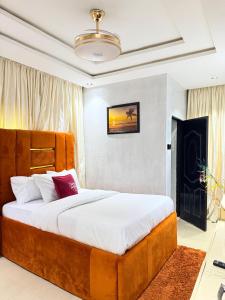a bedroom with a large bed and a fireplace at Dee's Apartment in Gwarinpa