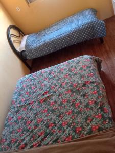 a bed and a couch in a room at Casa sobrado in Alegrete