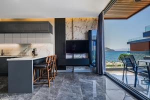 a kitchen with a view of the ocean at Bodrum Ada Suites Beach Hotel in Turgutreis