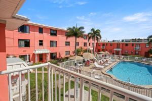 a balcony view of a resort with a swimming pool at Gulf Winds Resort by Travel Resort Services in St. Pete Beach