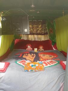 a bed in the back of a camper van with food on it at Small Rosie River Glamping Pod for 1 in Lincoln