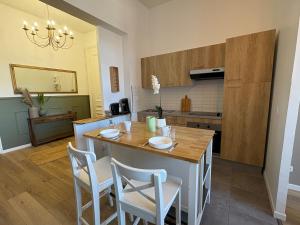 a kitchen with a table and chairs in a room at Le Cocon de St-Pierre in Calais