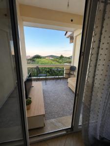 a view from a sliding glass door of a patio at Seaside Escape in Nea Peramos