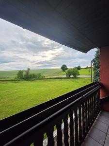 a balcony with a view of a green field at WoDa's Hütte in Wickerode +2 photos