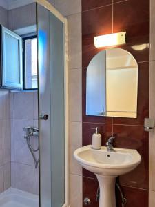 a bathroom with a sink and a mirror at Adzija House in Ohrid