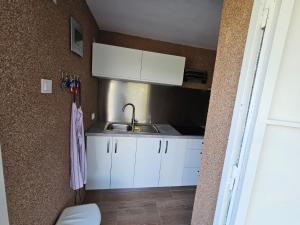 a small kitchen with a sink and a toilet at Loni in Klenovica +46 photos