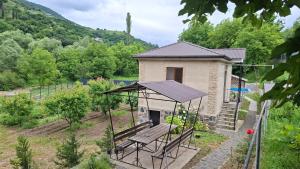 a small house with a bench in front of it at Shen toon cottage in Shnogh