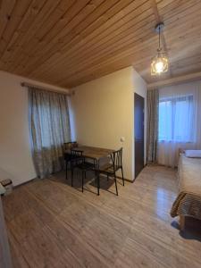 a living room with a table and a couch at Shen toon cottage in Shnogh