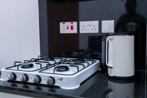 a stove top oven sitting on top of a kitchen counter at Onkundis Luxury Homes in Kiambu +15 photos