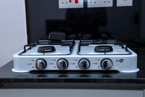 a white stove top oven sitting on top of a counter at Onkundis Luxury Homes in Kiambu