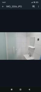 a picture of a bathroom with a sink and a mirror at Donwtonw in Arraial do Cabo