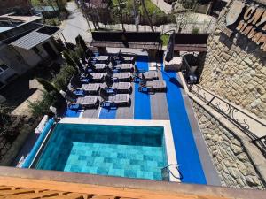 an overhead view of a swimming pool with lounge chairs at Княжий двір in Yaremche