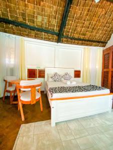 a bedroom with a bed and a table and a desk at 9 bedroom Villa in Mombasa +45 photos