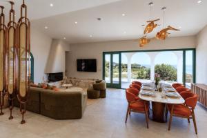 a living room with a table and a couch at Xenia Sea view Villa in Argassi