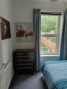 a bedroom with a bed and a window at Dover White Cliff Apartment in Dover
