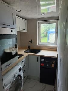 a small kitchen with a sink and a window at Dover White Cliff Apartment in Dover