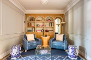 a living room with two chairs and a table at Casa Talavera by Tasman in Mexico City +128 photos