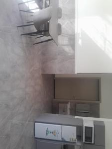 a kitchen with white cabinets and a counter top at شاليهات تايم in Khamis Mushayt +2 photos
