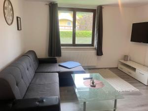 a living room with a couch and a table at Ferienhaus Michi in Ursprung